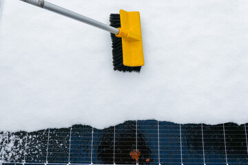 Snow Removal From Solar Panel With Brush.Solar Panel Efficiency in Winter.layers of snow on solar...
