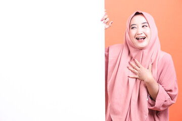 Joyful Muslim Woman Displaying a Blank Sign with Excitement, exu
