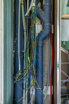 Inside of an home electricity breaker box with many colorful wires