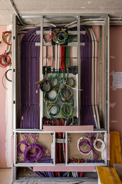 Inside of an home electricity breaker box with many colorful wires
