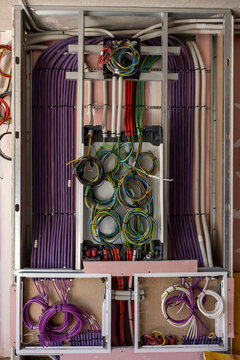 Inside of an home electricity breaker box with many colorful wires