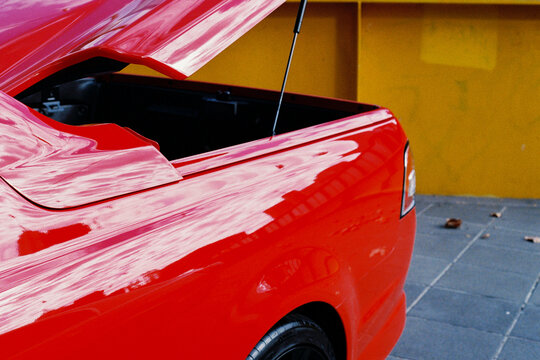 Red Car with Open Trunk Highlighting Vehicle Design
