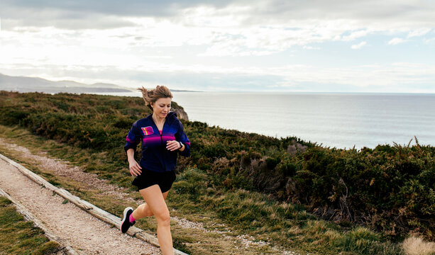 Woman running near ocean