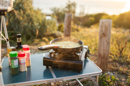 Outdoor Camping Dinner Setup by the Beach at Sunset in Portugal