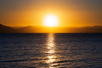 Serene Sunset Over Calm Waters: A Symphony of Colors Reflecting Tranquility