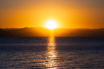 Serene Sunset Over Calm Waters: A Symphony of Colors Reflecting Tranquility