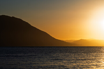 Serene Sunset Over Calm Waters: A Symphony of Colors Reflecting Tranquility
