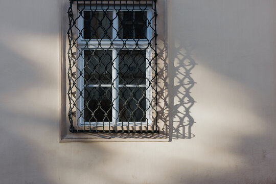 Window with decorative iron grill and shadow
