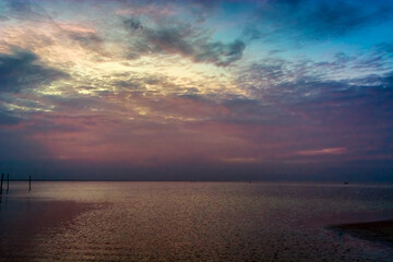 Fototapeta premium Sea beach with sky sunset or sunrise. Clouds over the sunset sea.