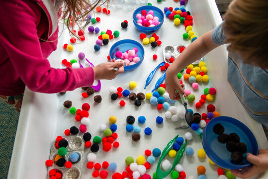 Children playing and learning at a sensory table in a preschool