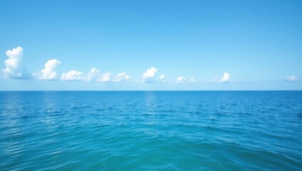 Obraz premium Endless Ocean View: Blue Water Under Bright Sunlight. Suitable for use in content related to travel, relaxation, environmental conservation