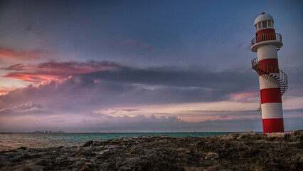 Lighthouse at sunset overlooking the Caribbean sea and sky in Mexico