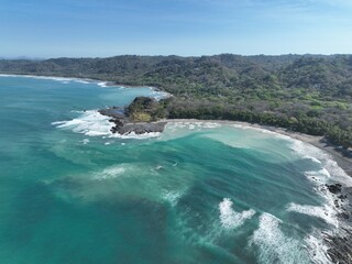 Montezuma Beach turquoise waters and volcanic rocks