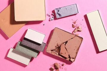 Beautiful eyeshadow refill pans on pink background, flat lay