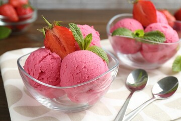 Tasty sorbet with strawberries and mint served on wooden table, closeup