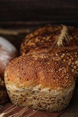 Freshly baked loaves of bread and spikes on table, closeup