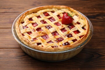 Tasty strawberry pie on wooden table, closeup