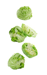 Fototapeta premium Fresh ripe cabbages falling on white background