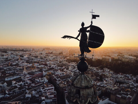 Historic wind vane in silhouette above Seville.