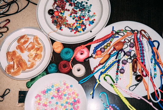 Crafting colorful accessories with beads and threads on a table