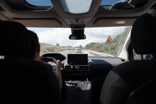 Woman driving modern car on scenic road trip
