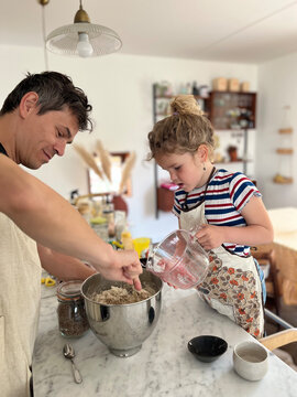 child carefully measuring ingredients in the kitchen.