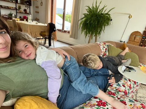 family enjoying cozy moments together on the sofa.