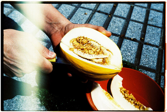 man cutting a slice of melon, 35mm film