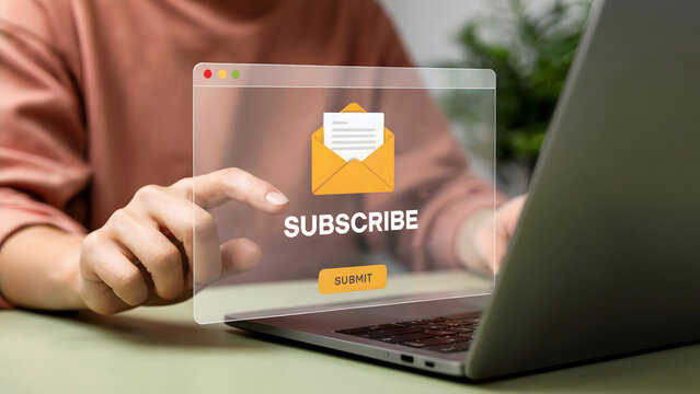 Woman interacts with an online subscribe form displayed on a laptop screen, indicating email sign-up and newsletter subscriptions for business marketing, with a green plant visible. - Powered by Adobe
