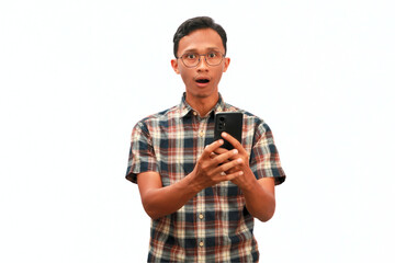 Fototapeta premium An Asian man holding a cellphone with a surprised expression