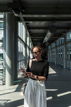 Businesswoman using smartphone in office building
