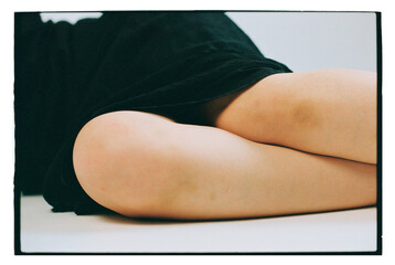 Female knees in warm studo light