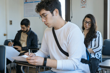 Group of students focused on writing in class