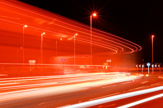 vehicle light trails on a roundabout at night