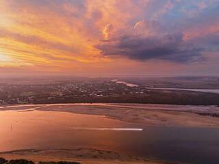 Colorful sunset sky over boat on a coastal river