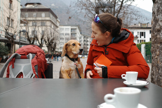 Woman and her dog take a break during a winter hike and have a coffee