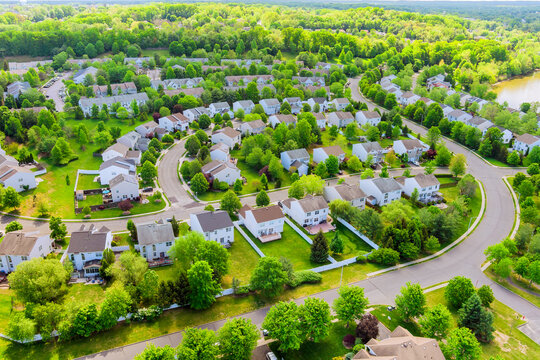 Suburban residential neighborhood with closely packed single family homes streets lined with mature trees landscape in East Brunswick, Middlesex County, New Jersey.