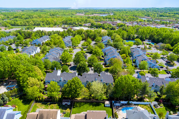 Residential neighborhood with multiple houses, neighborhood shows with green lawns, swimming pools, of suburban New Jersey in Middlesex County, suburban settlement.