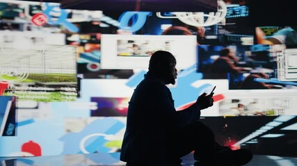 African american person deals with consequences of overusing social networks, faces stress and mental health due to digital dependence. Facing harmful toxic information overload. Camera A. - Powered by Adobe