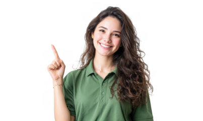 A cheerful young woman wearing a green polo shirt points to the side. showcasing a friendly demeanor in a bright. minimalist setting ideal for promotional or advertising purposes