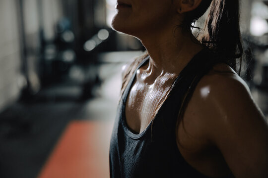 Focused Woman Relaxing After High-Intensity Gym Workout Session