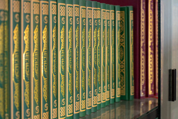 Islamic books neatly arranged on a shelf inside a mosque