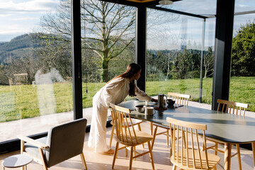 A tourist setting the table for breakfast during a green getaway