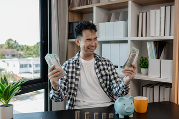 he is saving money for his future plans, putting some if his income in a piggy bank, he is saving...