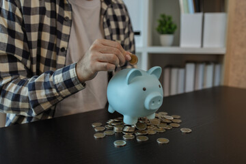 he has a lot of coins, he saves for retirement, he puts the coins in a piggy bank, the piles of...