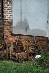 Two broken wooden chairs in an abandoned old house, showing decay and neglect
