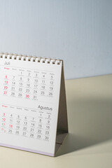 Close up of a white desk calendar showing specific date, captured from an angled macro perspective.