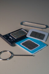 Close up macro of SIM card and SIM tray ejector tool