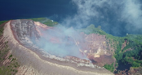 White smoke rising from the active volcano crater in Ende, Flores Island, Indonesia, captured in...