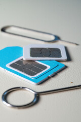 Close up macro of SIM card and SIM tray ejector tool